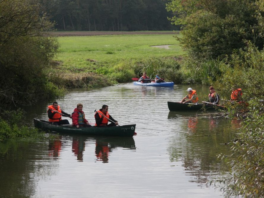 Kanufahrt auf einem Fluss - alle tragen Schwimmweste